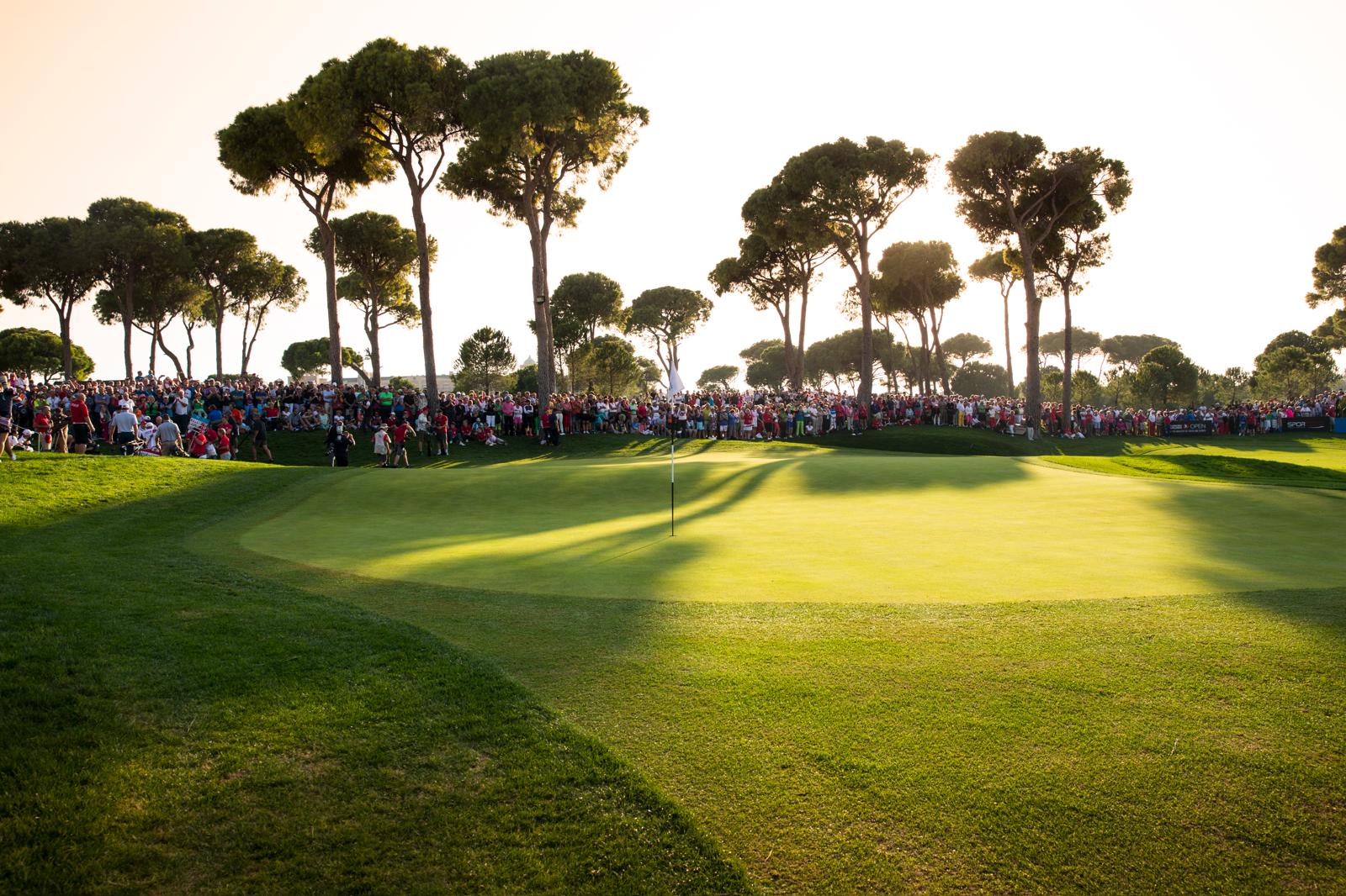 Championship golf course green with tournament spectators